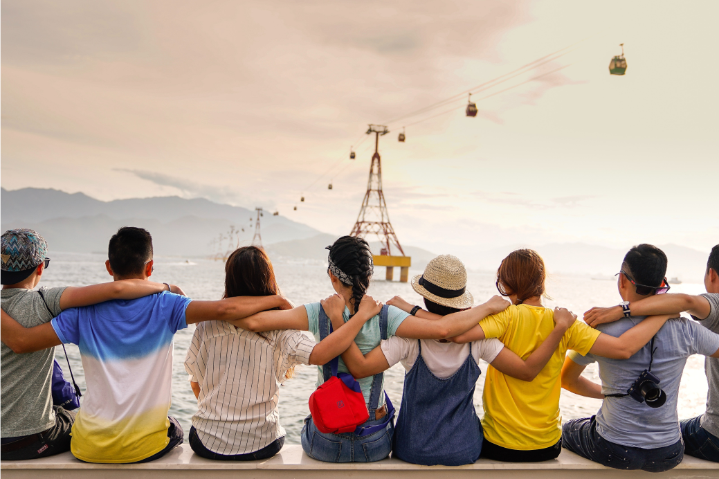 Behind shot of people sitting with their arms on each shoulders