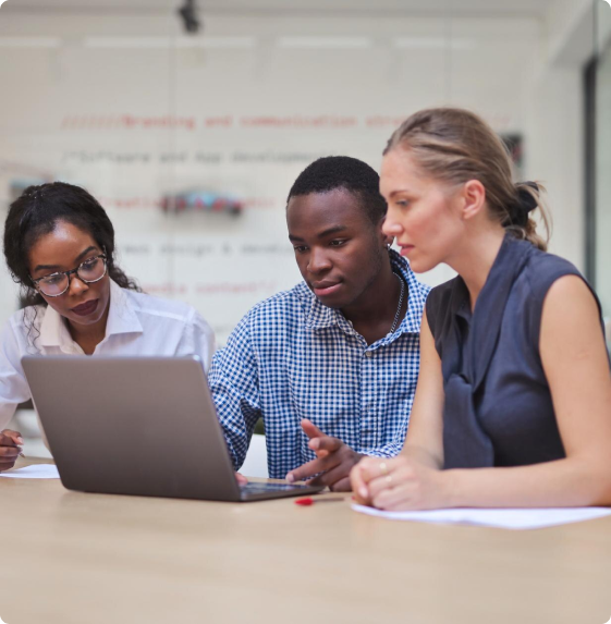 Three people looking at a laptop